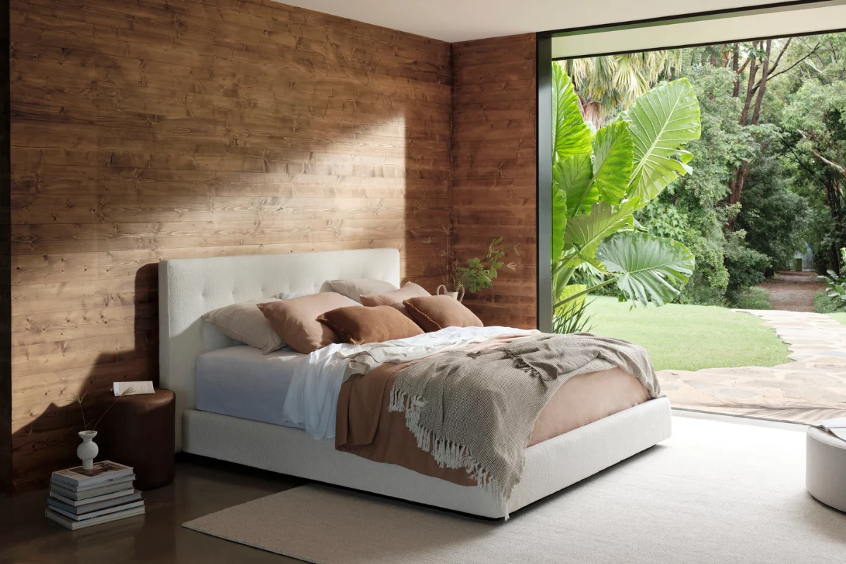 Person preparing for evening relaxation in a calm bedroom setting